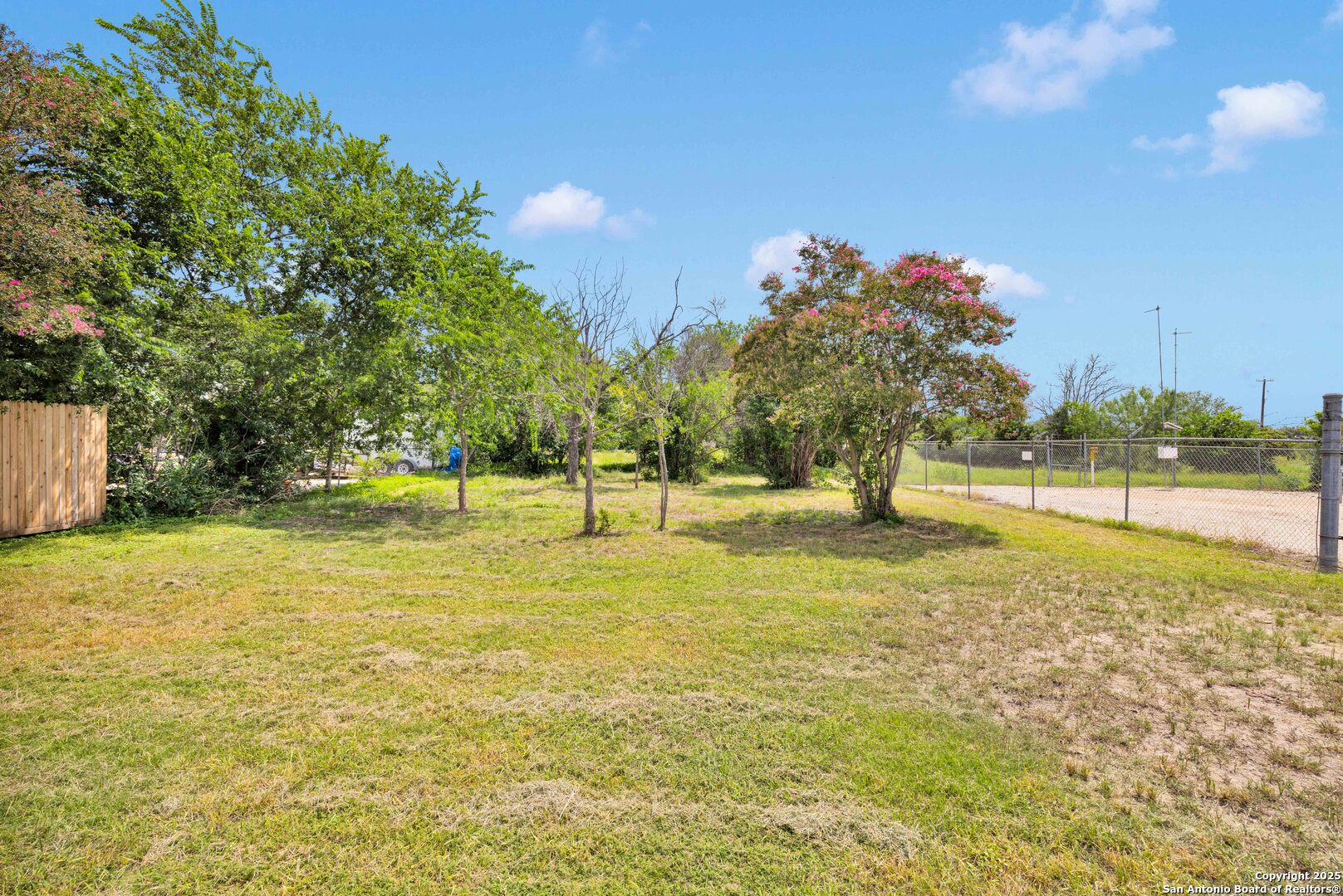 a view of yard with swimming pool and trees