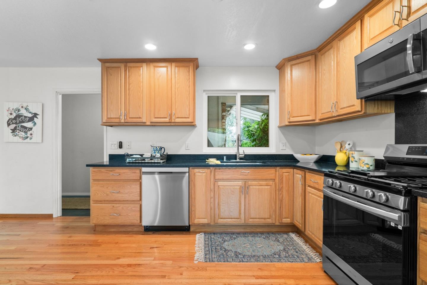 314 Hames Road Watsonville, CA 95076 - Photo 14 of 32 a kitchen with stainless steel appliances granite countertop a stove a sink and a microwave