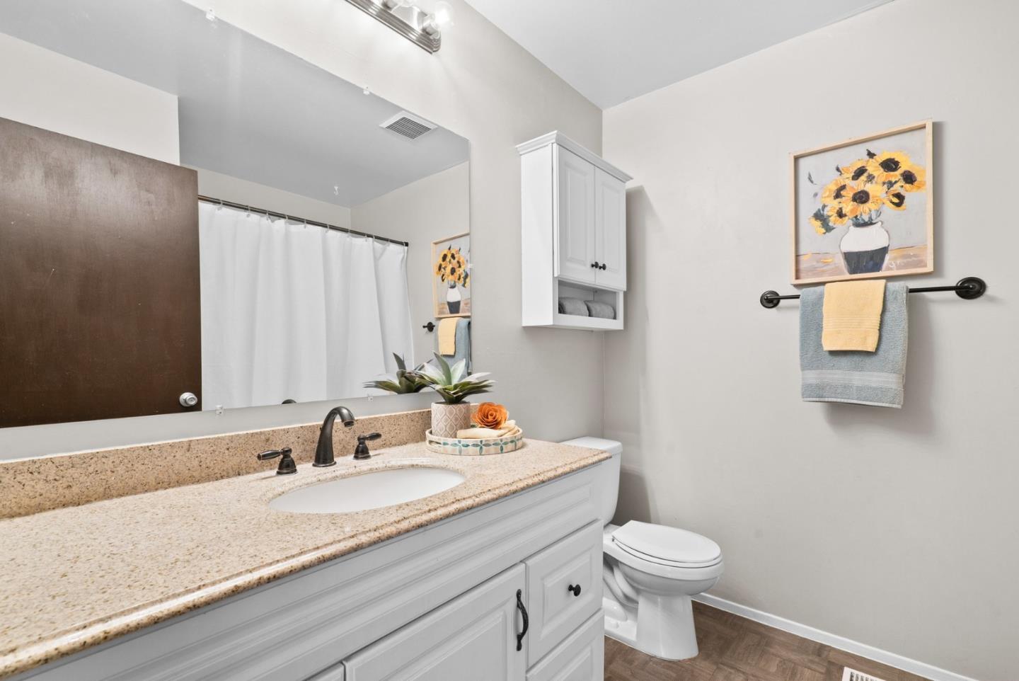 314 Hames Road Watsonville, CA 95076 - Photo 21 of 32 a bathroom with a granite countertop sink mirror vanity and toilet