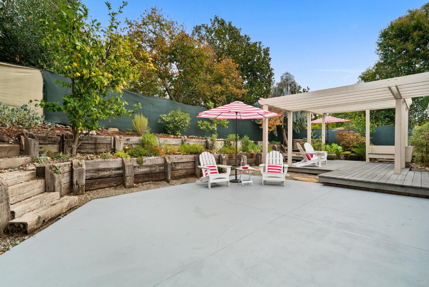314 Hames Road Watsonville, CA 95076 - Photo 30 of 32 a view of a patio with dining table and chairs under an umbrella with a barbeque