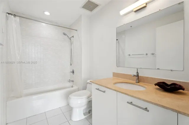 a bathroom with a granite countertop sink a toilet and shower