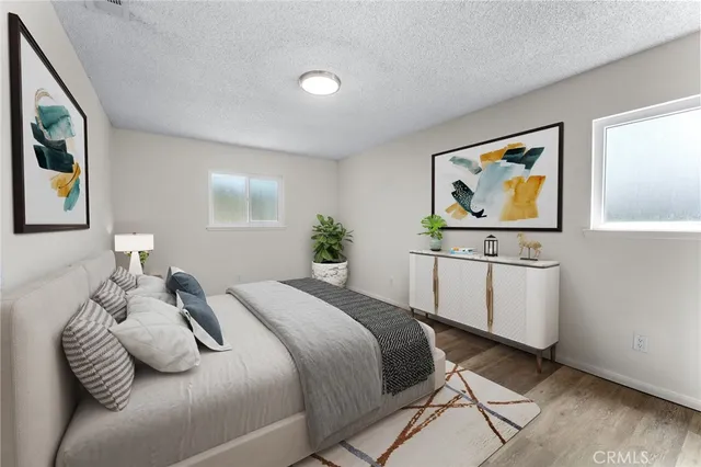 a bedroom with a bed and painting on the wall