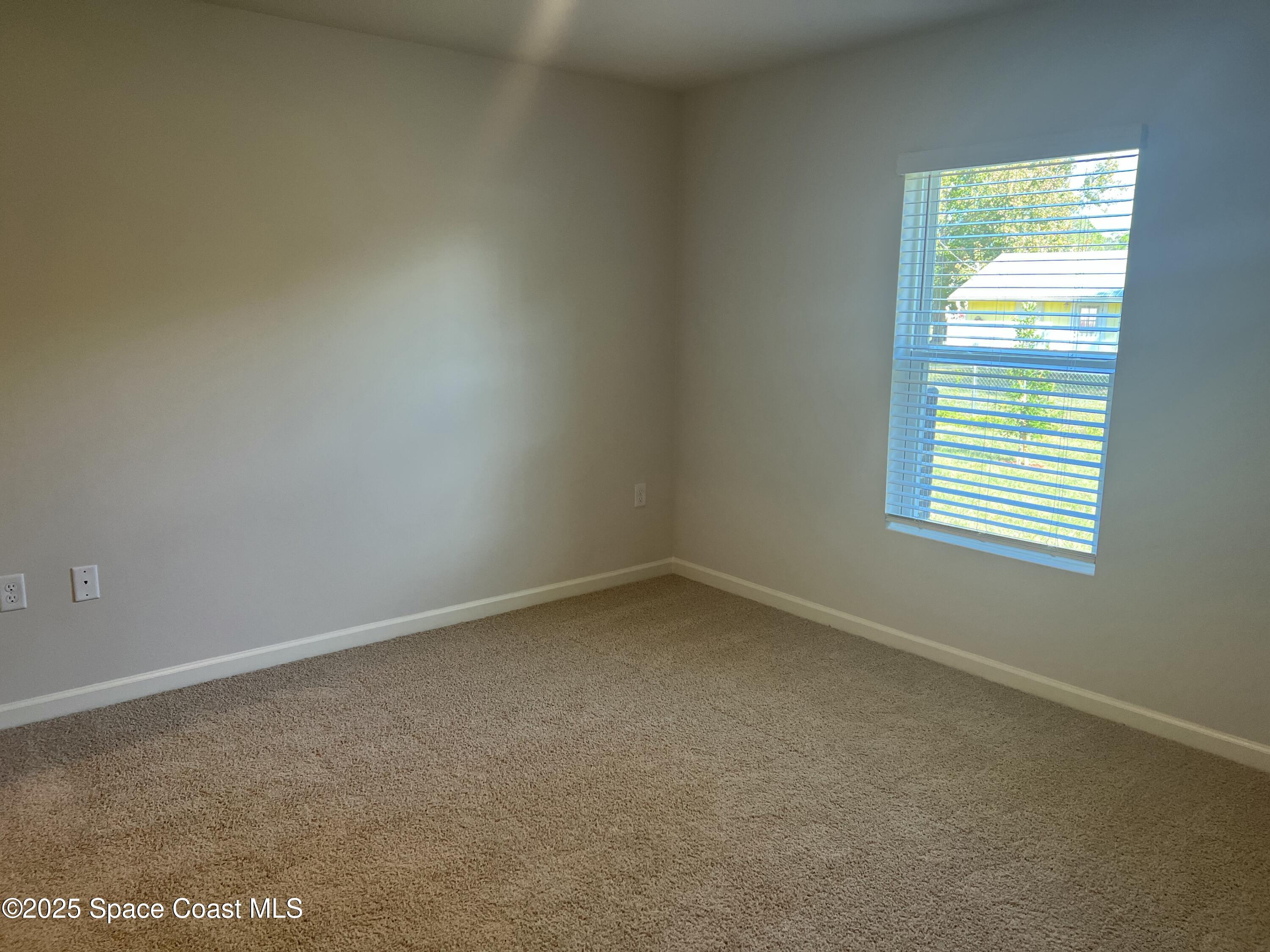 881 Hollahan Road Southeast Palm Bay, FL 32909 - Photo 18 of 21 an empty room with a window