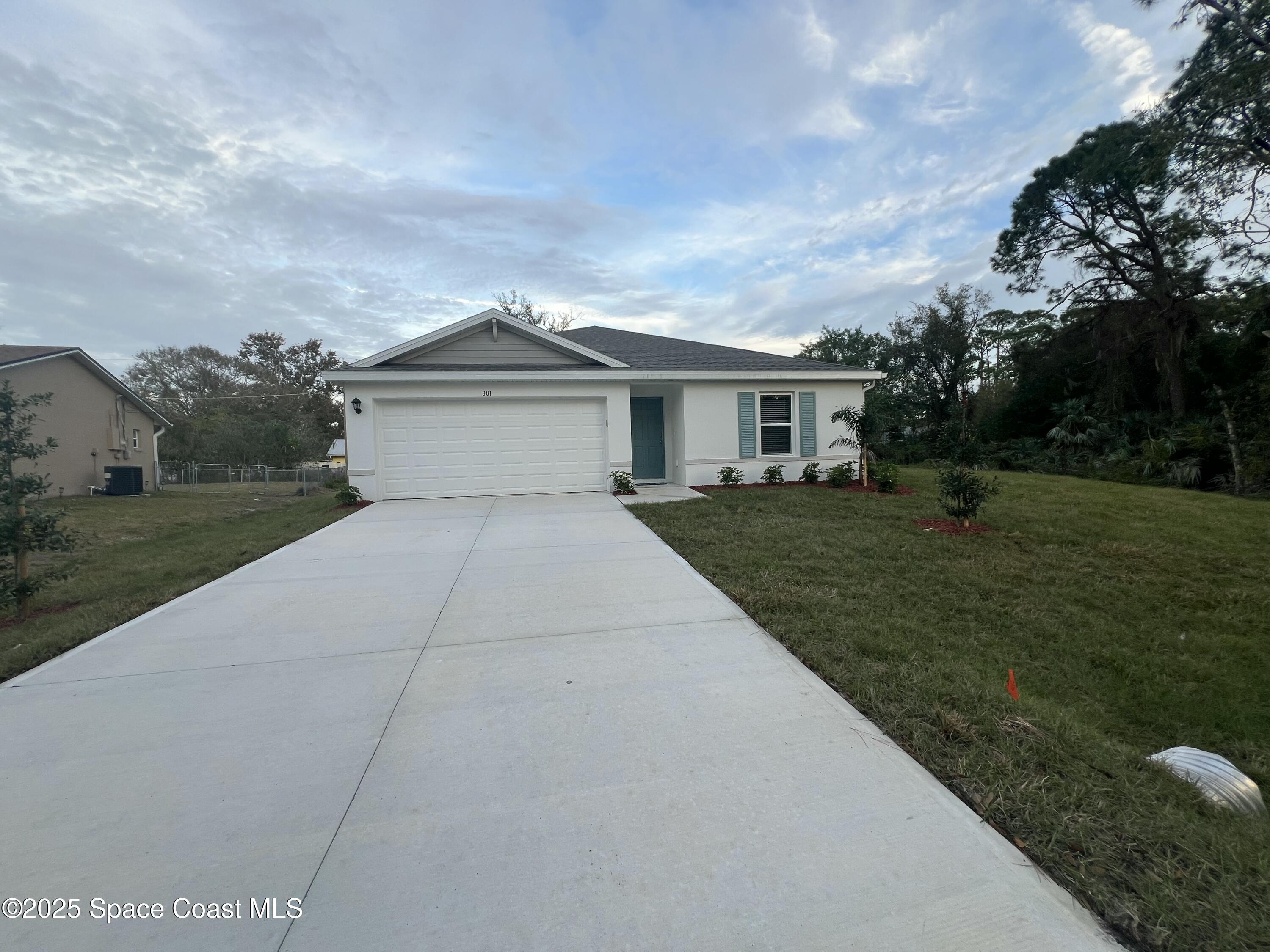 881 Hollahan Road Southeast Palm Bay, FL 32909 - Photo 2 of 21 a front view of house with yard and green space
