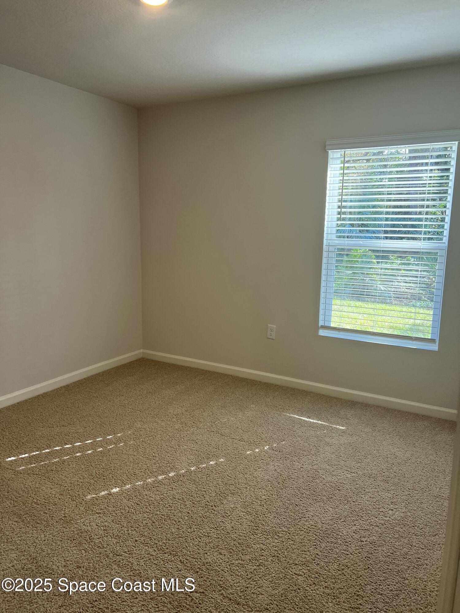 881 Hollahan Road Southeast Palm Bay, FL 32909 - Photo 9 of 21 a view of an empty room with a window