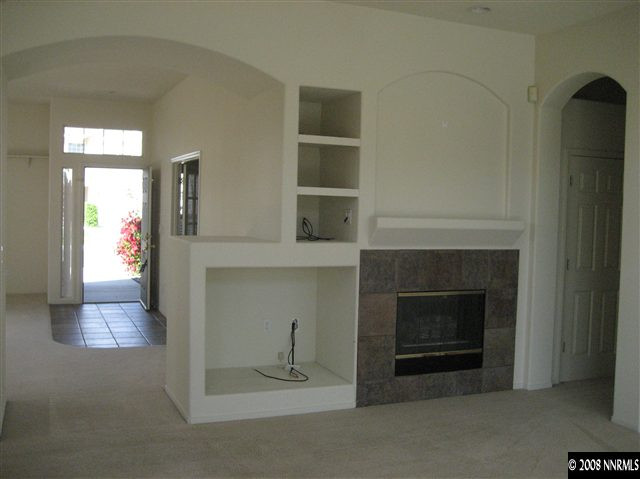 9590 Oakley Lane Reno, NV 89521 - Photo 4 of 9 an empty room with fireplace