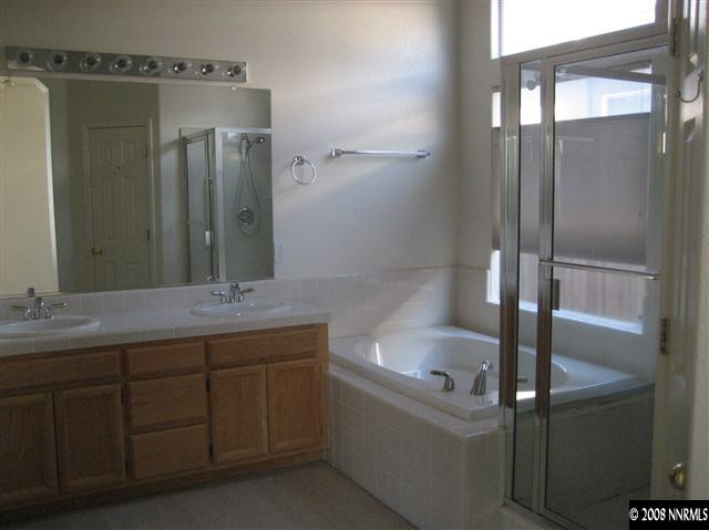 9590 Oakley Lane Reno, NV 89521 - Photo 8 of 9 a bathroom with a bathtub and a sink
