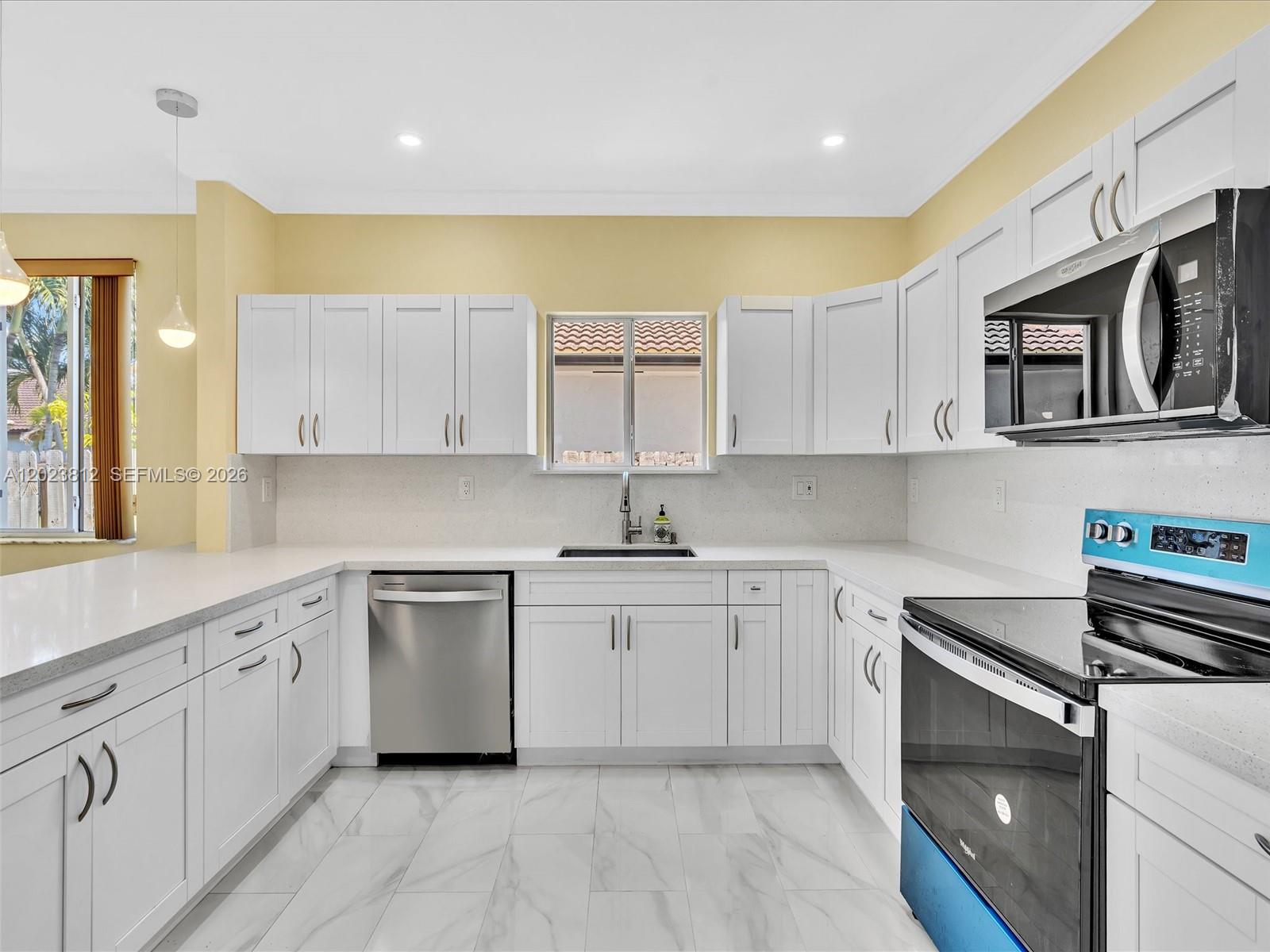 2864 Southwest 138th Path Miami, FL 33175 - Photo 19 of 40 a kitchen with stainless steel appliances granite countertop a sink and cabinets