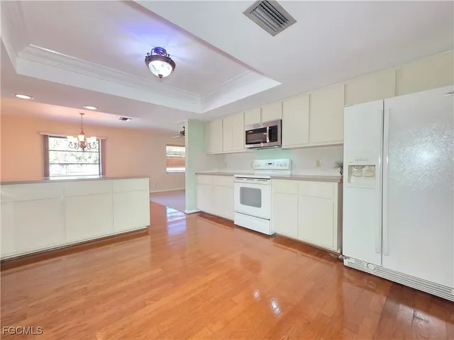 a kitchen with stainless steel appliances a refrigerator sink and microwave