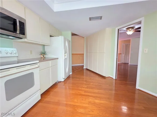 a kitchen with stainless steel appliances a stove microwave and sink