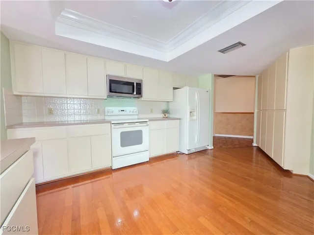 a kitchen with a stove a sink and a refrigerator
