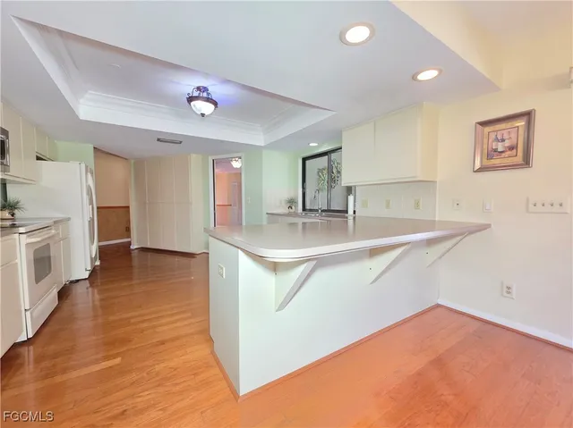 a kitchen with stainless steel appliances granite countertop a sink and a refrigerator