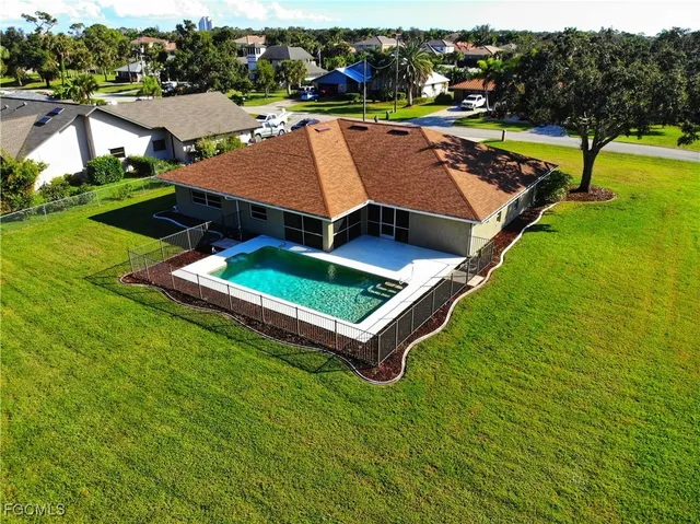 an aerial view of a house with a garden and swimming pool