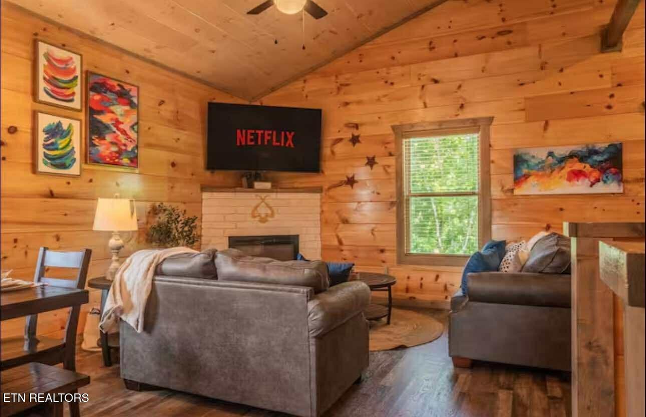 2033 Eagle Feather Drive Sevierville, TN 37876 - Photo 5 of 27 a living room with furniture a fireplace and a flat screen tv