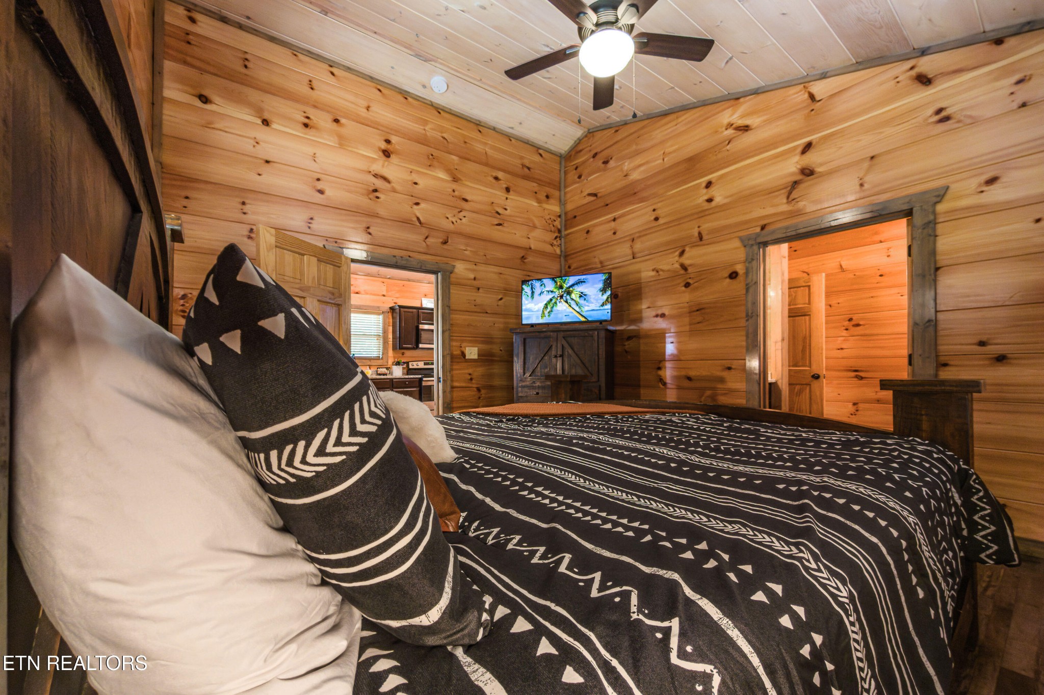 2033 Eagle Feather Drive Sevierville, TN 37876 - Photo 8 of 27 a bedroom with a bed and a chandelier