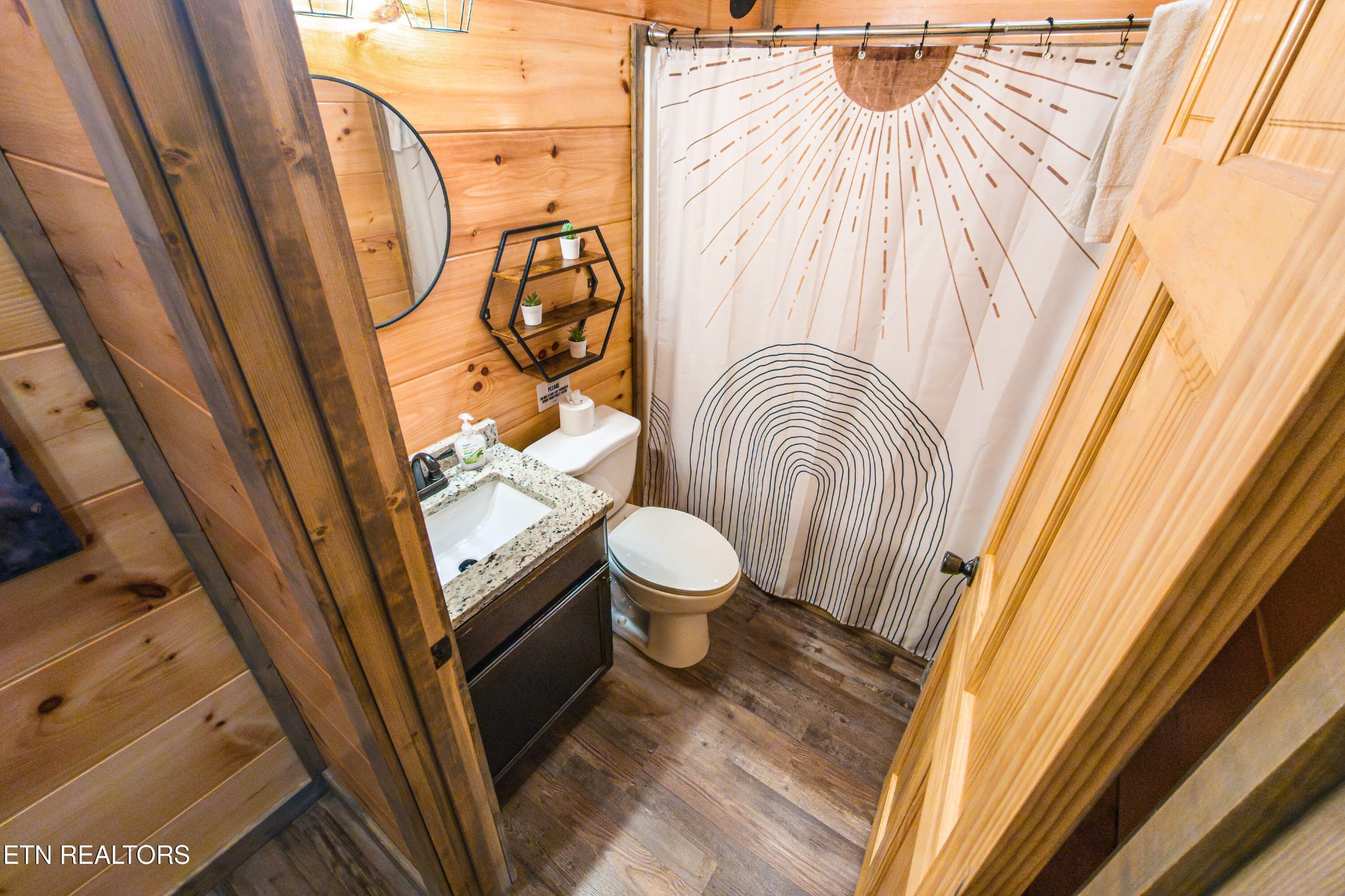 2033 Eagle Feather Drive Sevierville, TN 37876 - Photo 10 of 27 a bathroom with a sink a toilet and a mirror