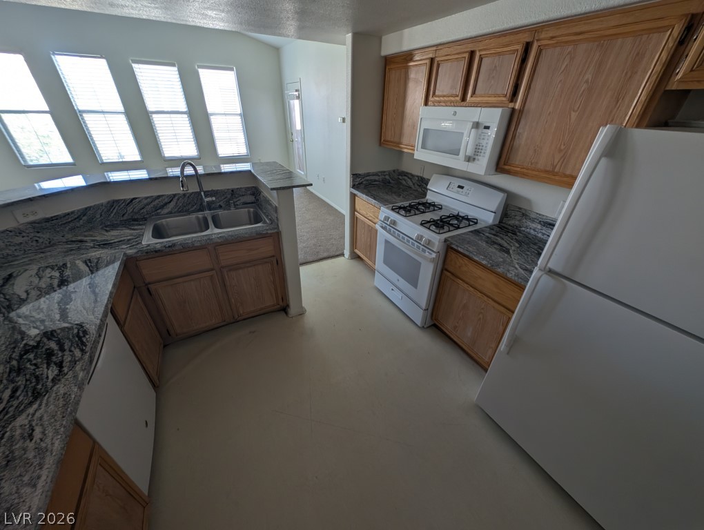 10550 West Alexander Road, Unit 2117 Las Vegas, NV 89129 - Photo 11 of 24 Striking granite countertops pair beautifully with oak cabinetry in this functional workspace.