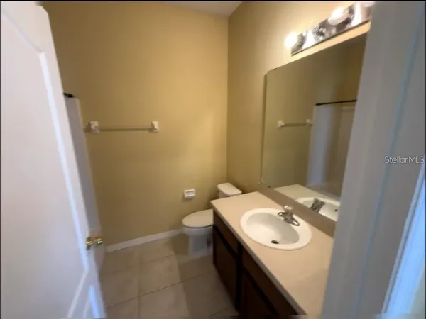 a bathroom with a sink toilet and mirror