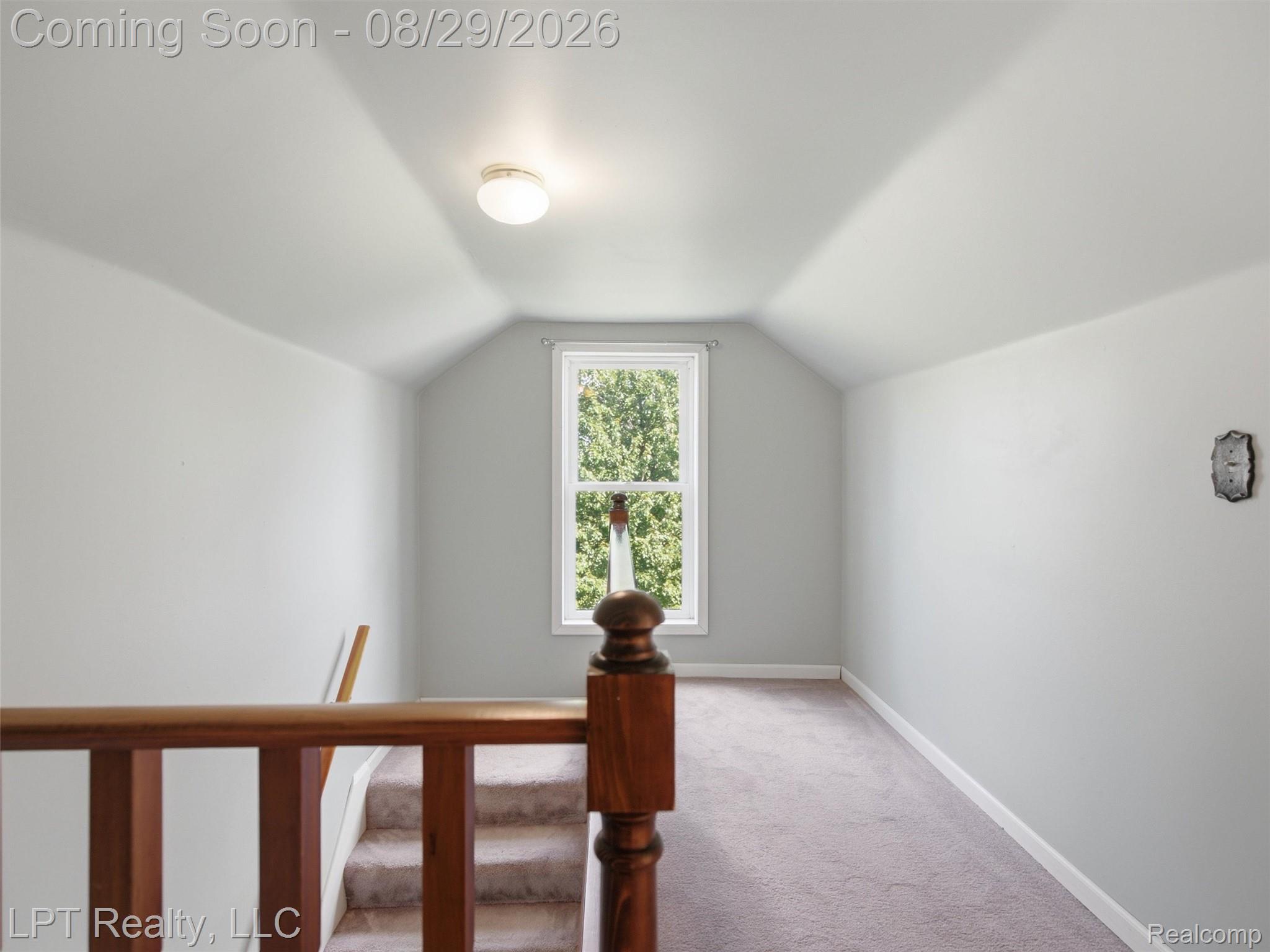 154 Bullis Road Gregory, MI 48137 - Photo 28 of 37 Attic space featuring a window, carpeted flooring, and a flush mount ceiling light