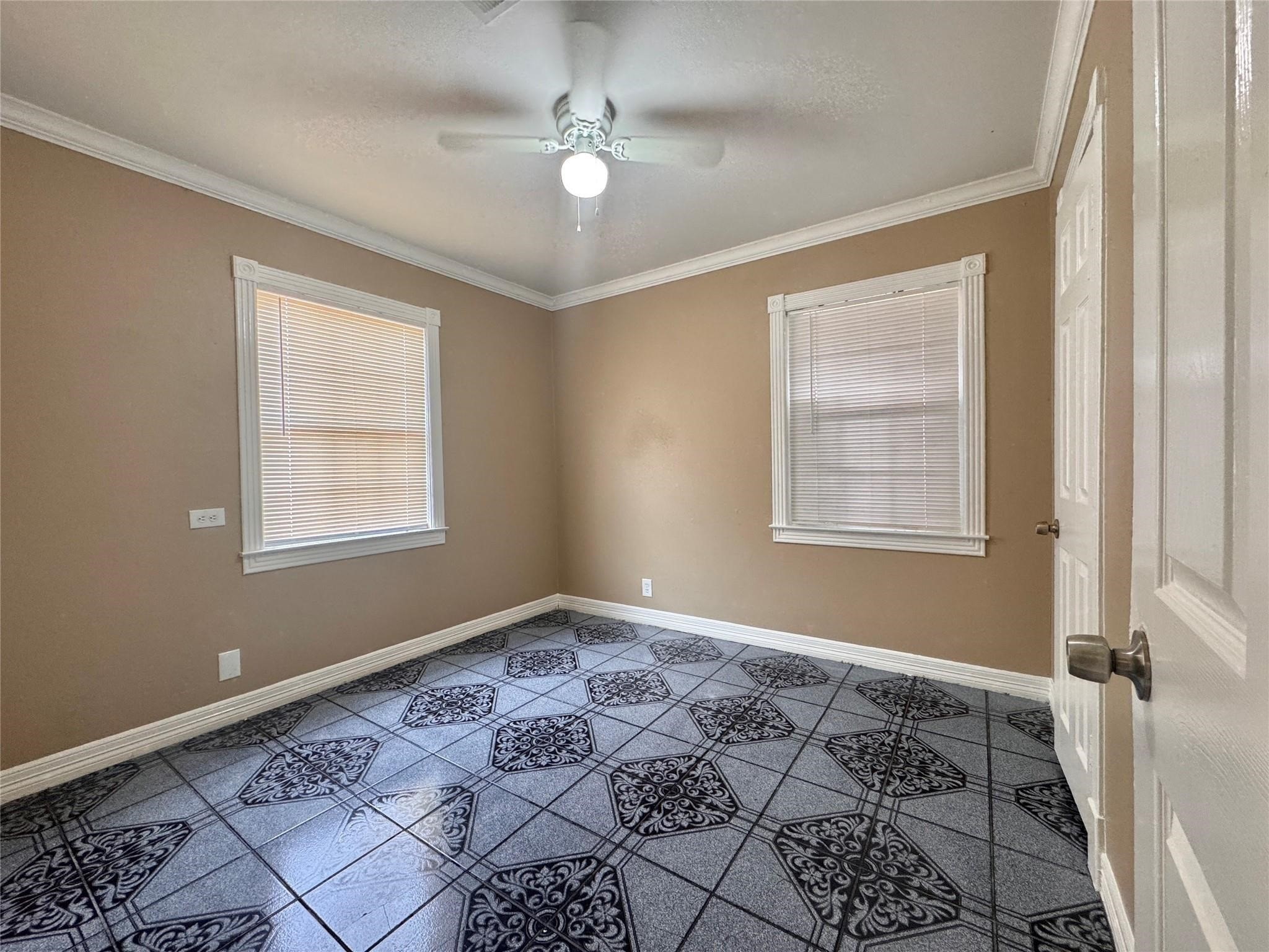 6602 Clemson Street Houston, TX 77092 - Photo 11 of 13 a bedroom with a bed and a window