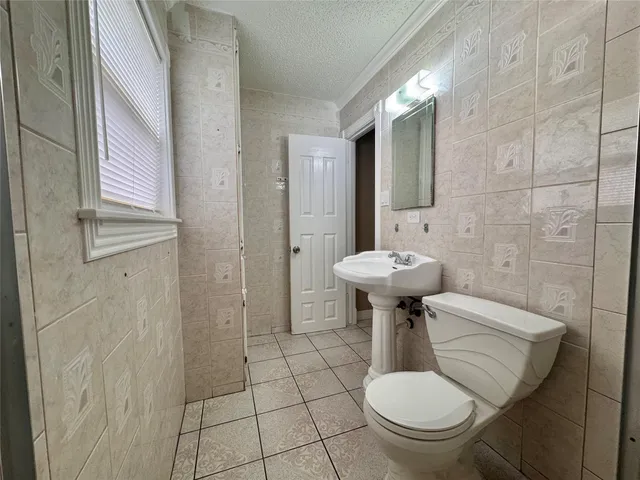 a bathroom with a sink toilet and a mirror