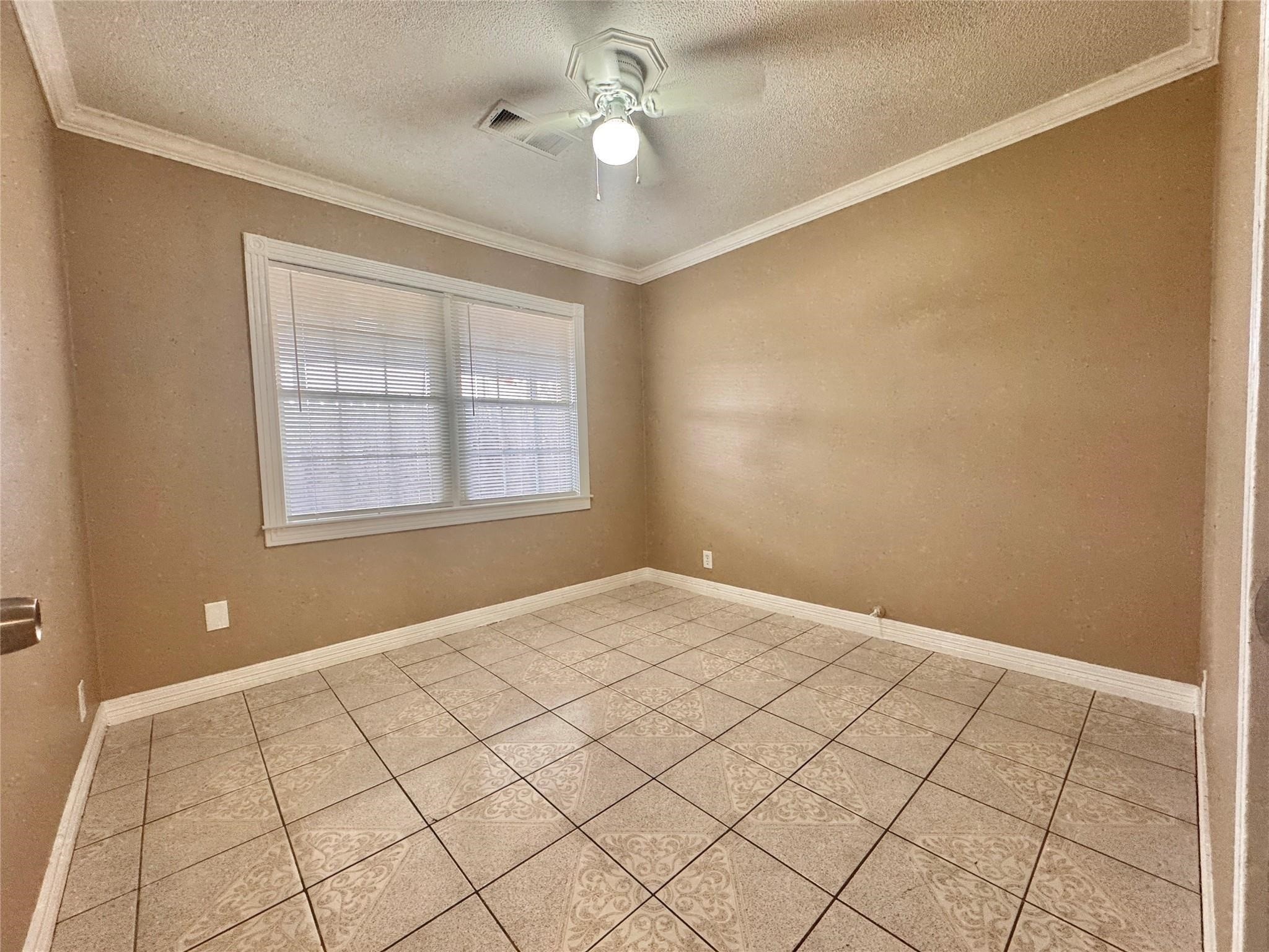 6602 Clemson Street Houston, TX 77092 - Photo 9 of 13 a view of an empty room with a window