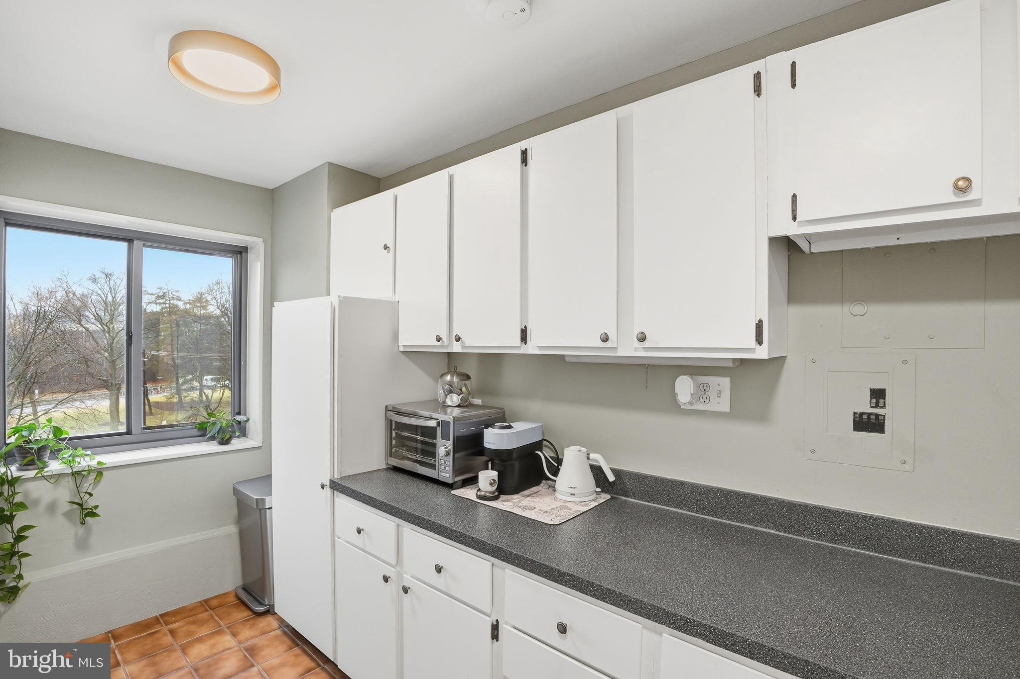 1300 South Arlington Ridge Road, Unit 204 Arlington, VA 22202 - Photo 14 of 35 a kitchen with stainless steel appliances granite countertop a sink a stove and white cabinets