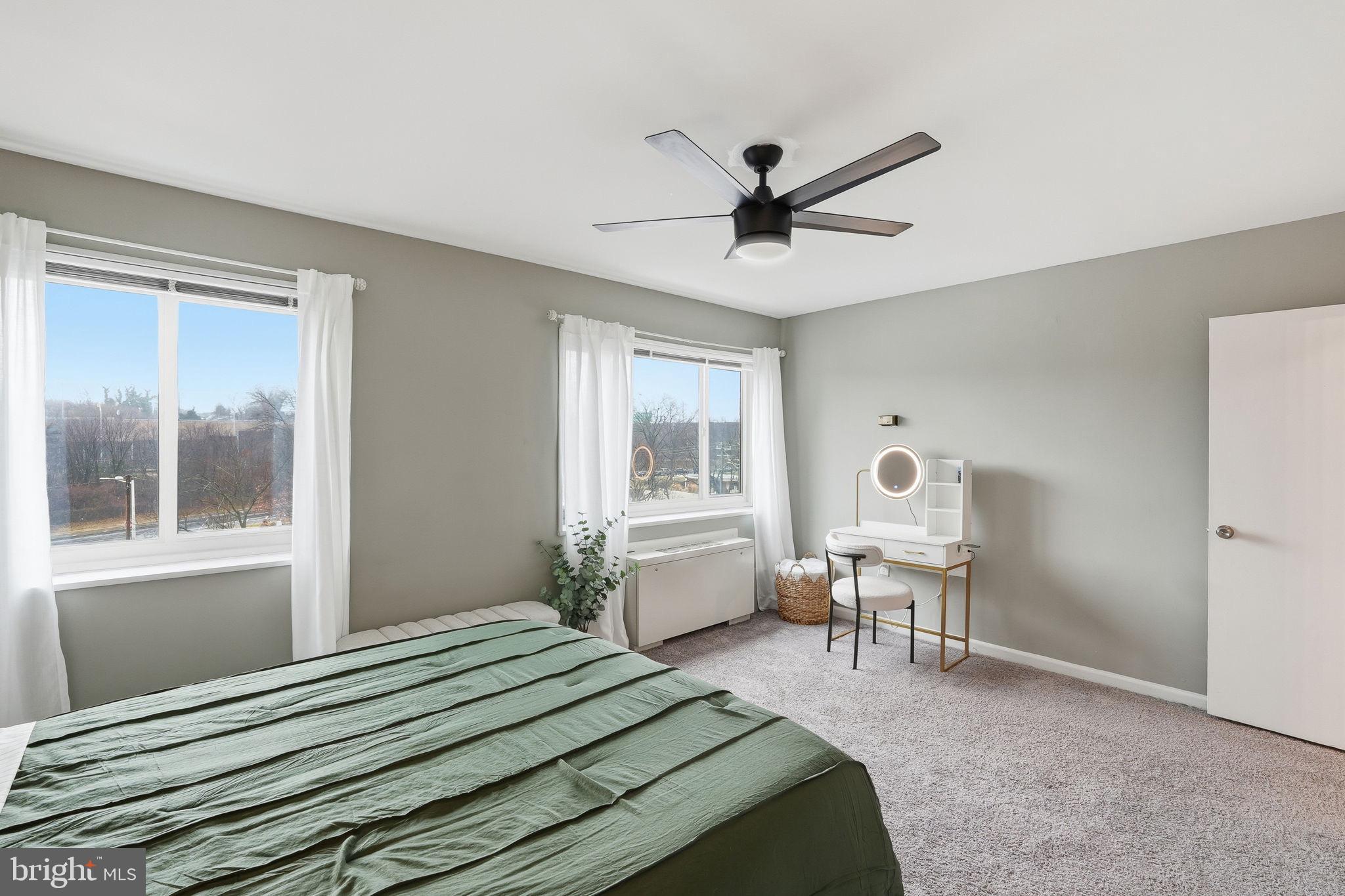 1300 South Arlington Ridge Road, Unit 204 Arlington, VA 22202 - Photo 18 of 35 a bedroom with a bed chandelier and a window