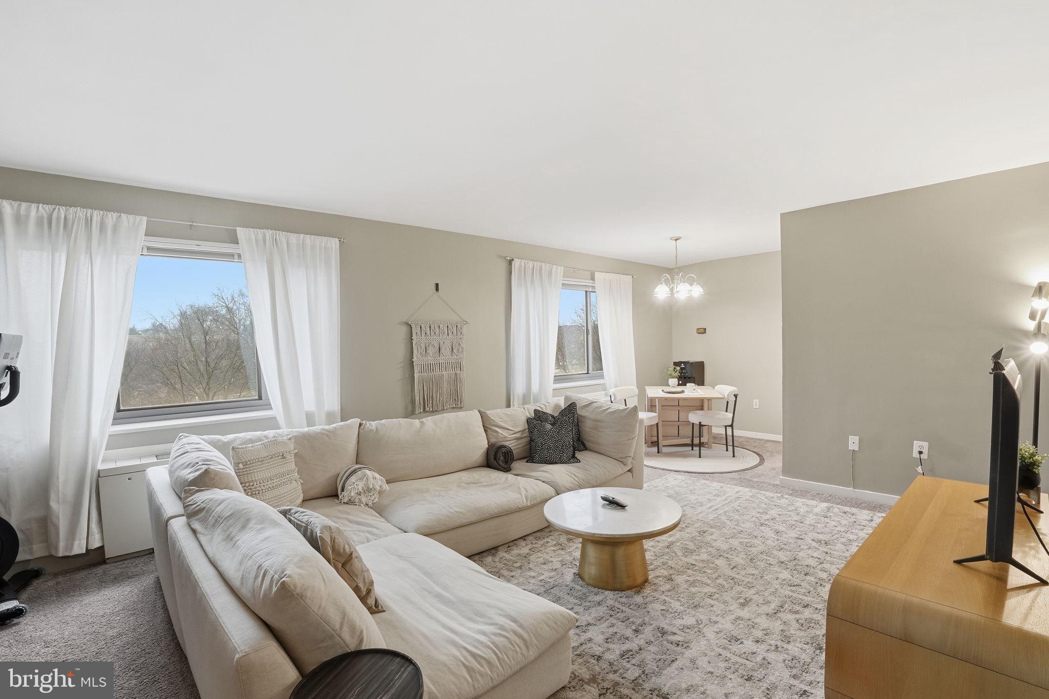 1300 South Arlington Ridge Road, Unit 204 Arlington, VA 22202 - Photo 2 of 35 a living room with furniture and a large window