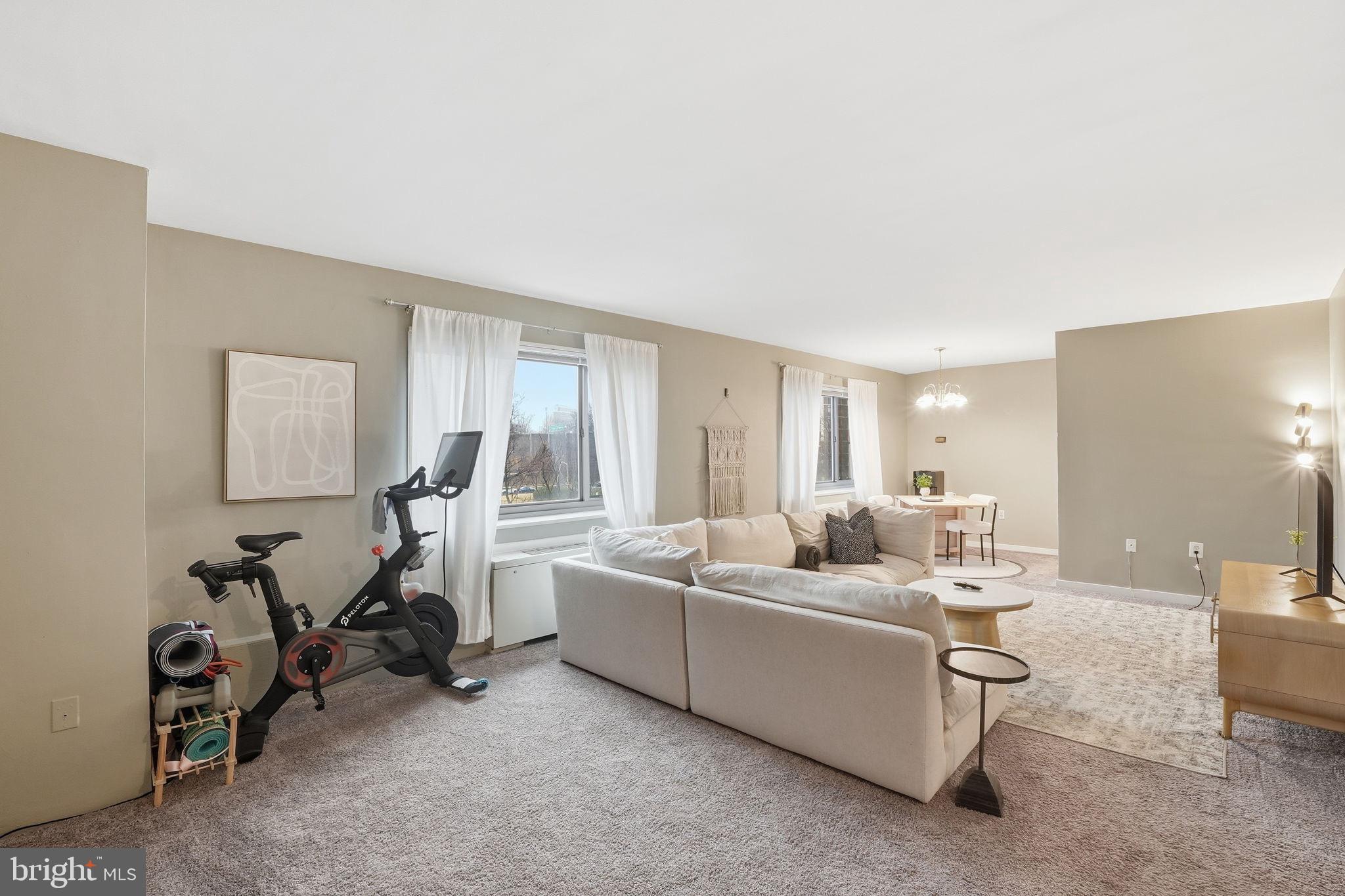 1300 South Arlington Ridge Road, Unit 204 Arlington, VA 22202 - Photo 4 of 35 a living room with furniture and a gym machine