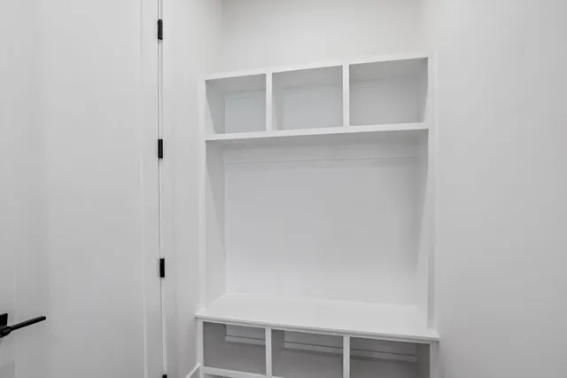 a view of walk in closet with empty racks