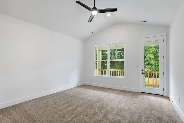 an empty room with chandelier fan