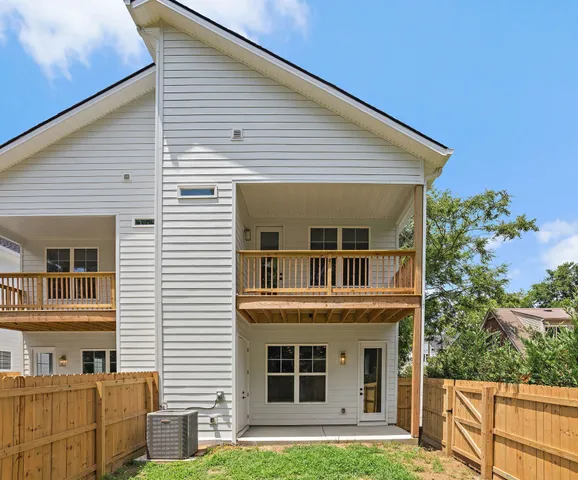 a view of a yard with wooden fence
