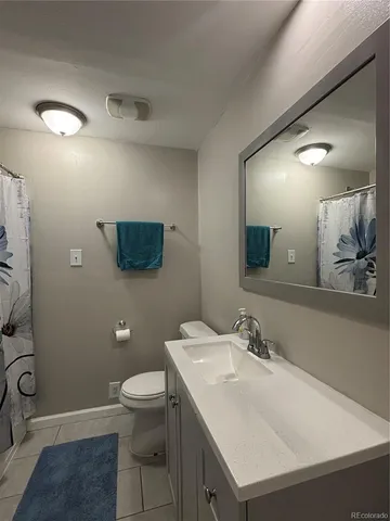 a bathroom with a sink toilet and a mirror