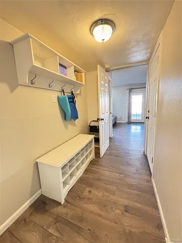 a view of a room with wooden floor