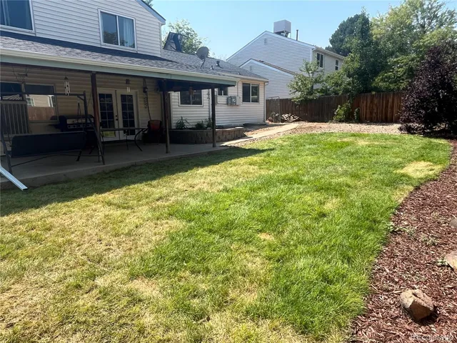 a backyard of a house with yard and outdoor seating