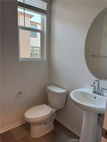 a white toilet sitting next to a bathroom sink