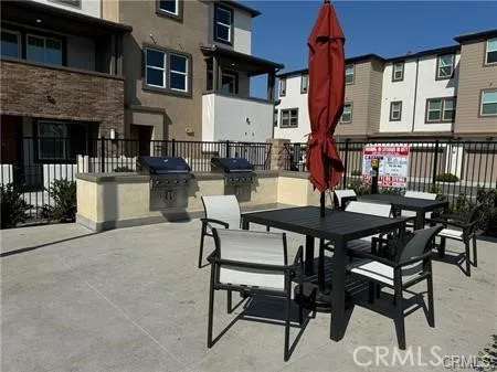a view of a patio with a table and chairs