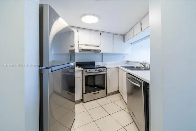a kitchen with stainless steel appliances granite countertop a sink and cabinets