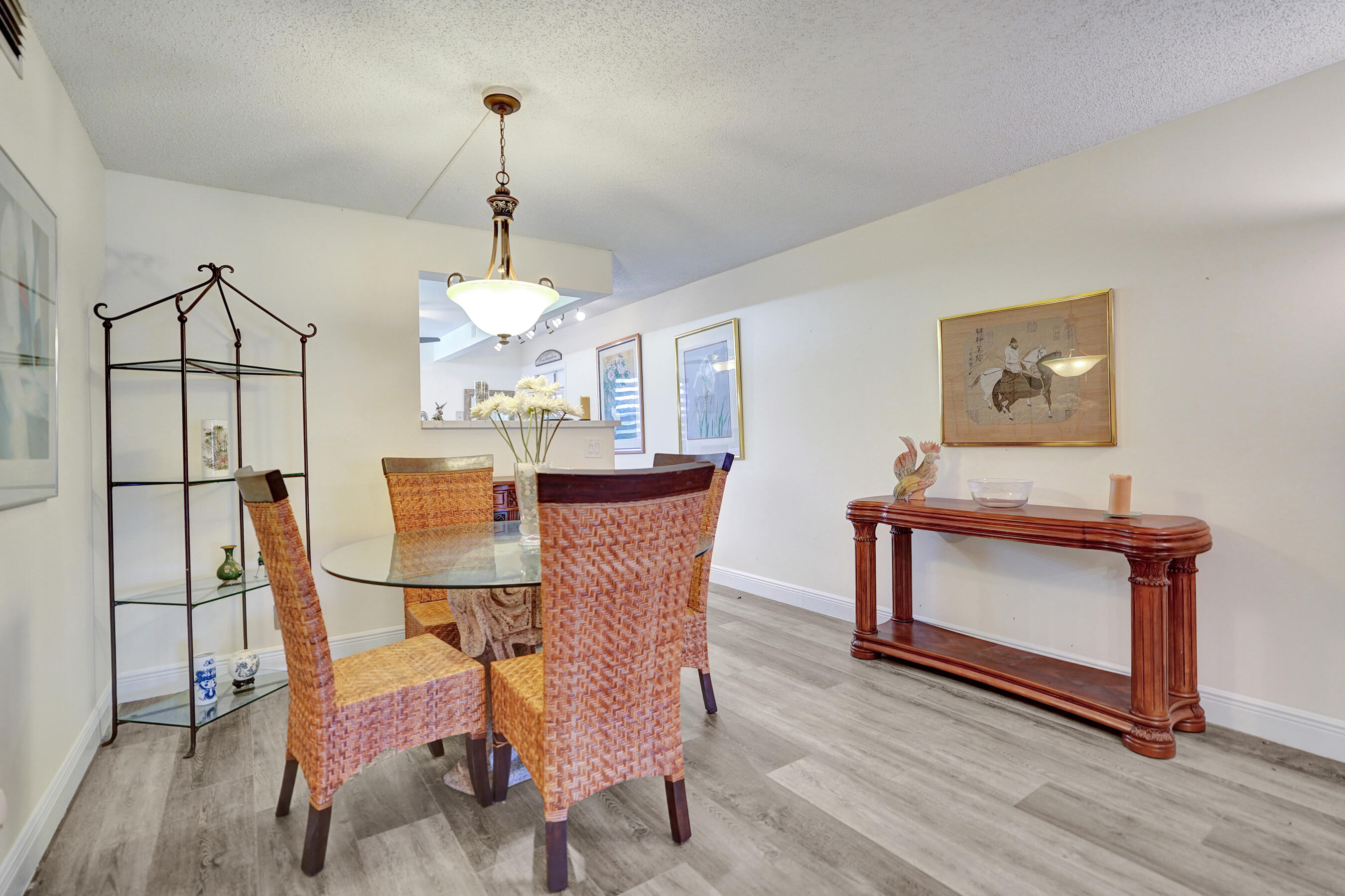 1033 Ainslie C Boca Raton, FL 33434 - Photo 12 of 42 a dining room with furniture a chandelier and wooden floor