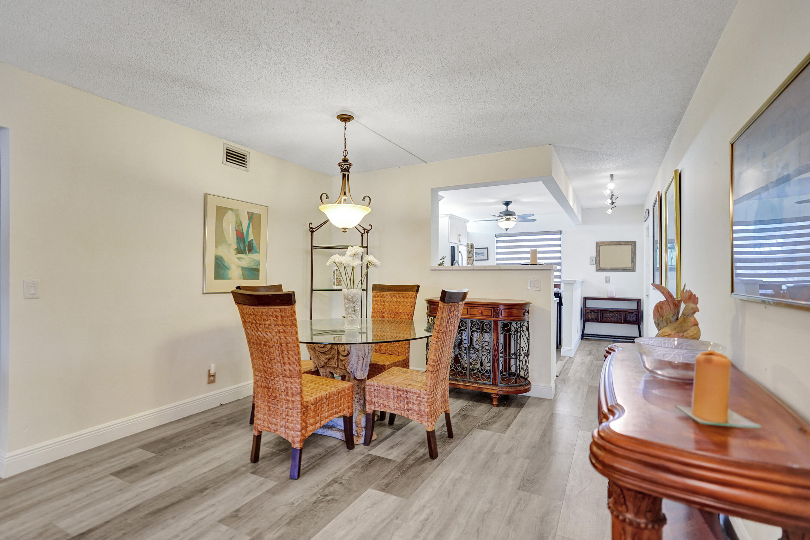 1033 Ainslie C Boca Raton, FL 33434 - Photo 14 of 42 a dining room with furniture and wooden floor