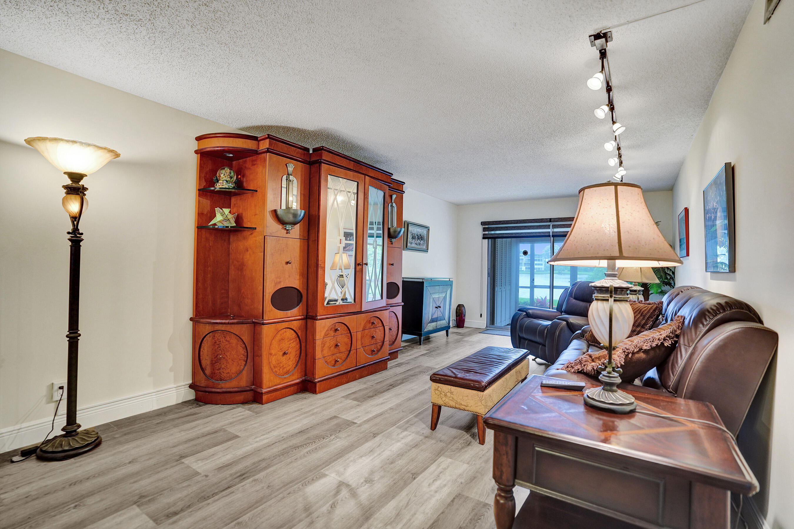 1033 Ainslie C Boca Raton, FL 33434 - Photo 16 of 42 a view of a workspace with furniture and wooden floor