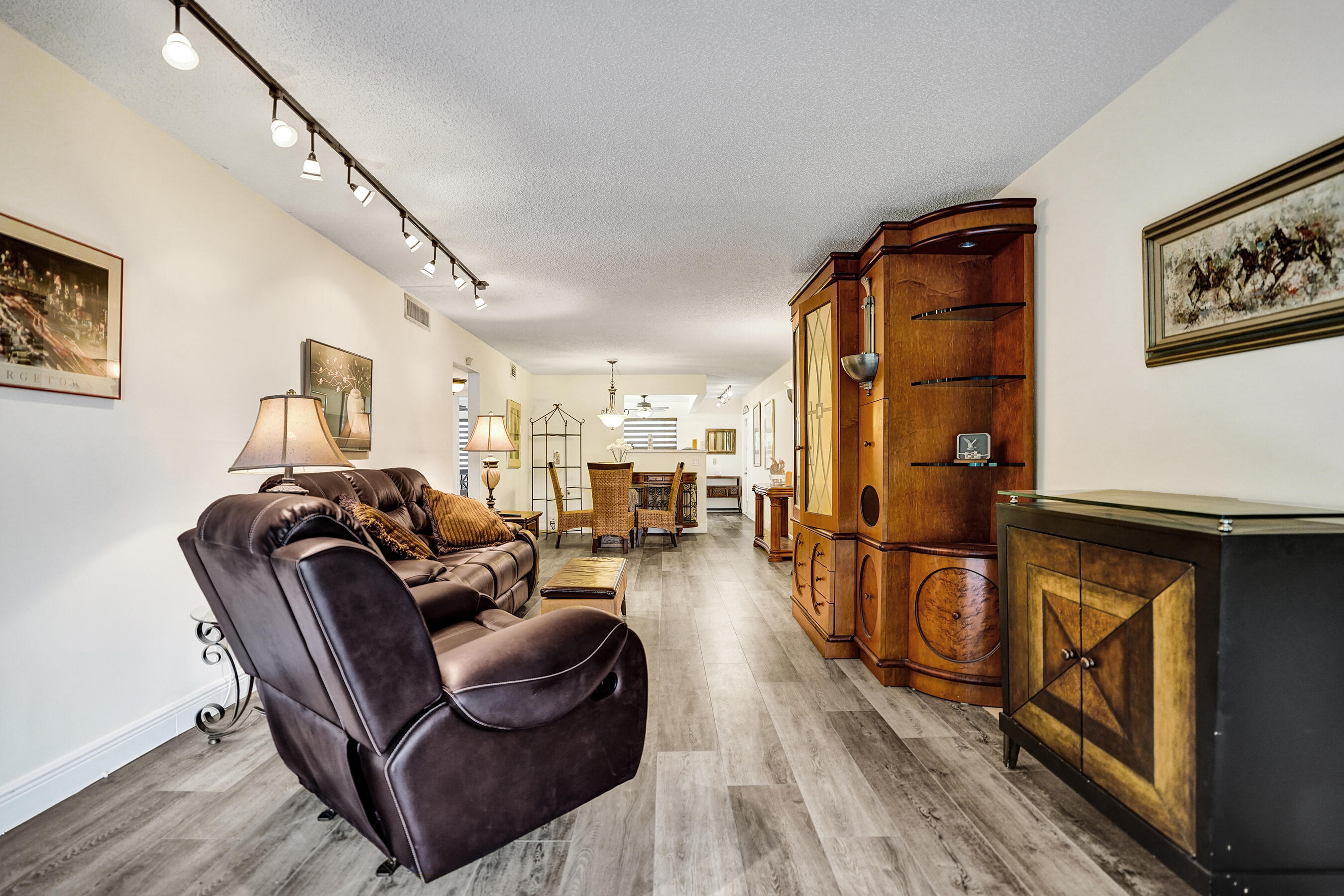 1033 Ainslie C Boca Raton, FL 33434 - Photo 22 of 42 a living room with furniture a fireplace and wooden floor