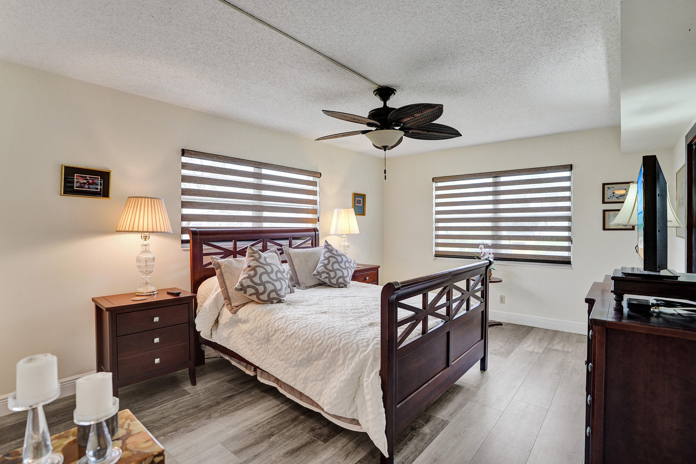 1033 Ainslie C Boca Raton, FL 33434 - Photo 23 of 42 a bedroom with a bed and a tv on dresser