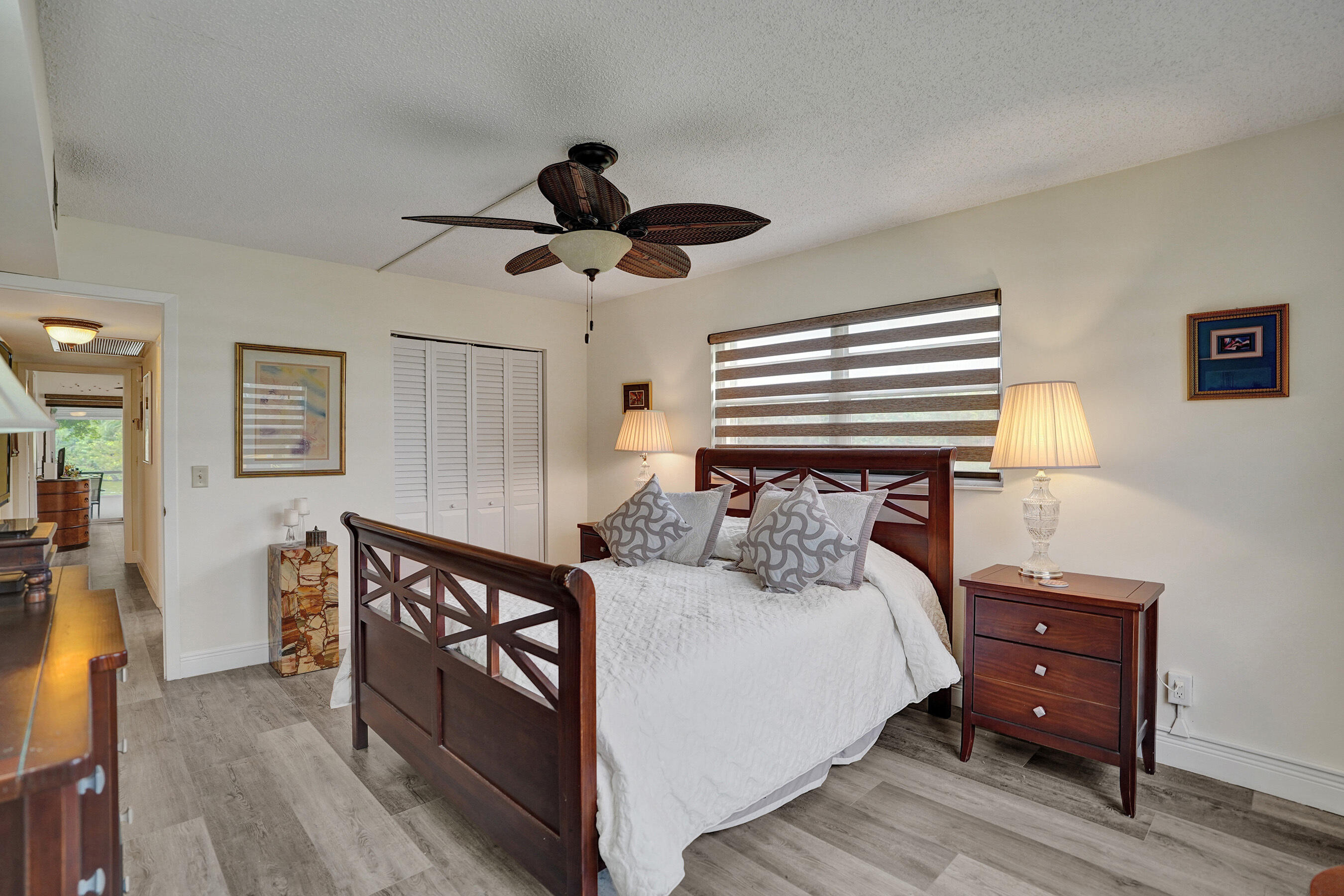 1033 Ainslie C Boca Raton, FL 33434 - Photo 24 of 42 a bedroom with a bed chandelier and a window
