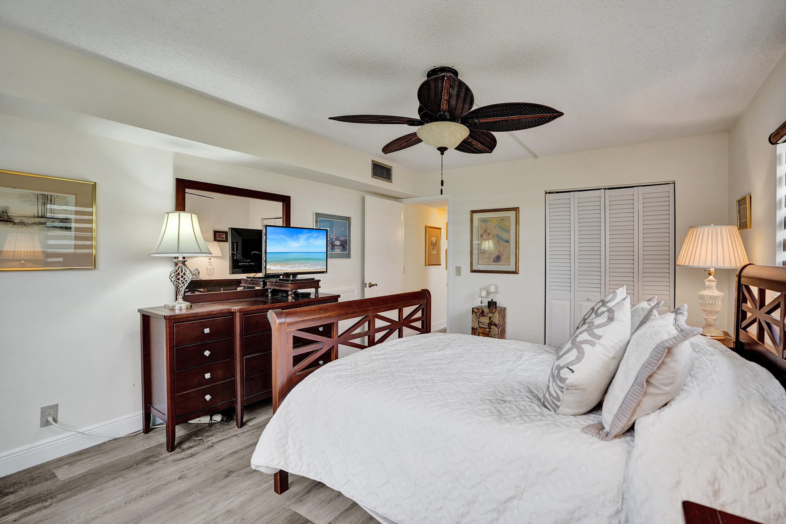 1033 Ainslie C Boca Raton, FL 33434 - Photo 25 of 42 a bedroom with a bed and wooden floor