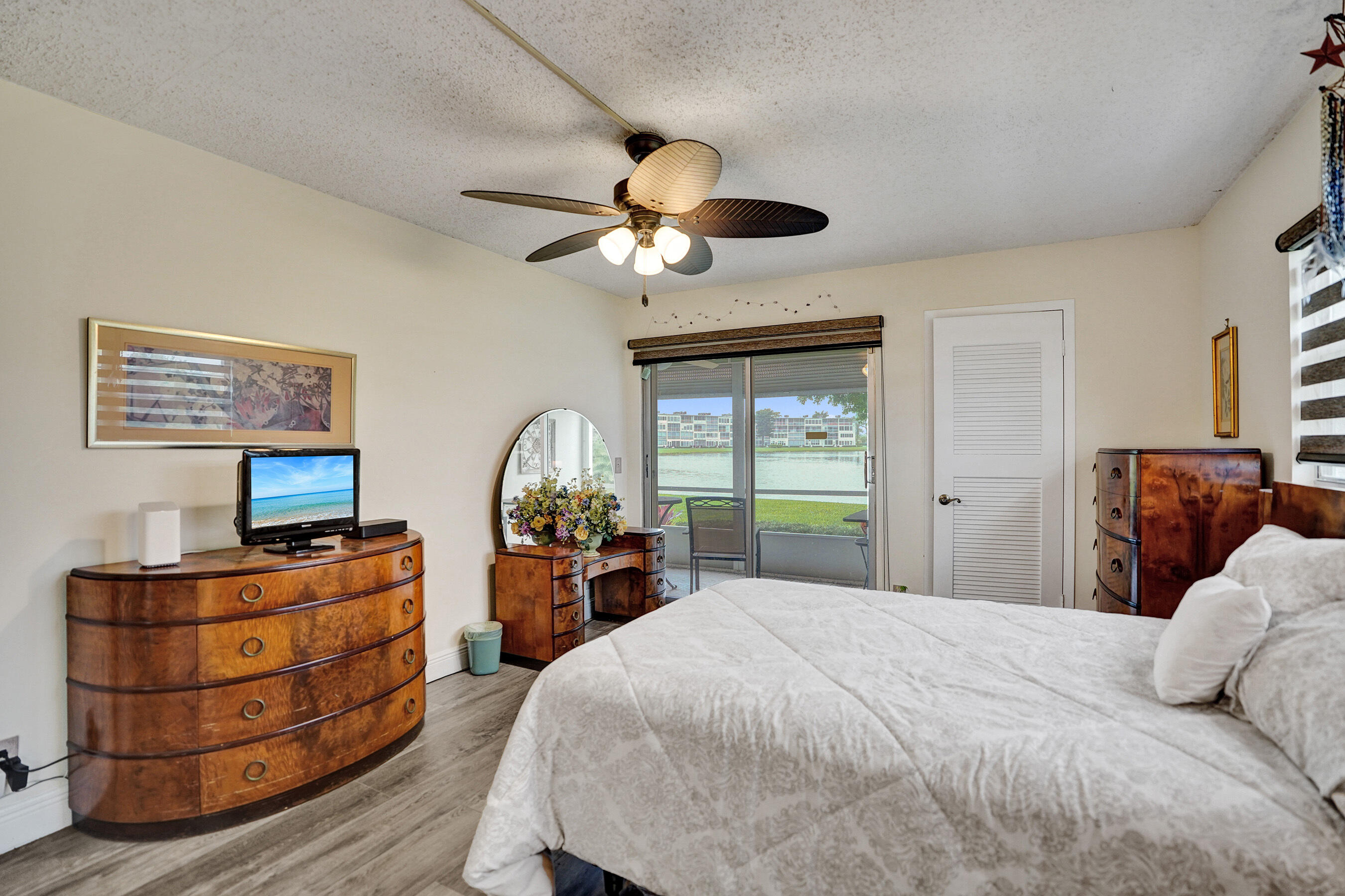 1033 Ainslie C Boca Raton, FL 33434 - Photo 28 of 42 a bedroom with a bed and a chandelier