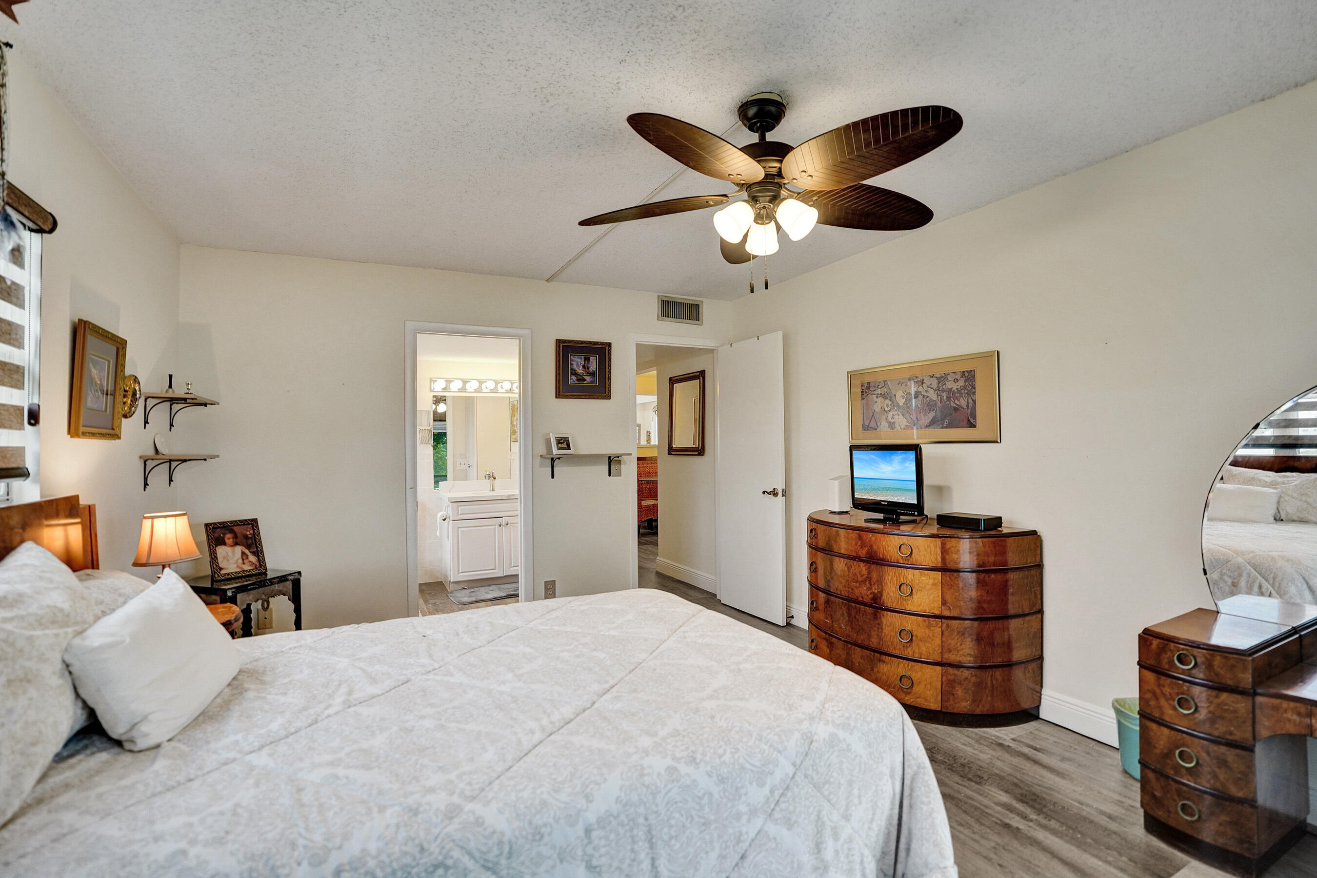 1033 Ainslie C Boca Raton, FL 33434 - Photo 29 of 42 a bedroom with a bed and dresser