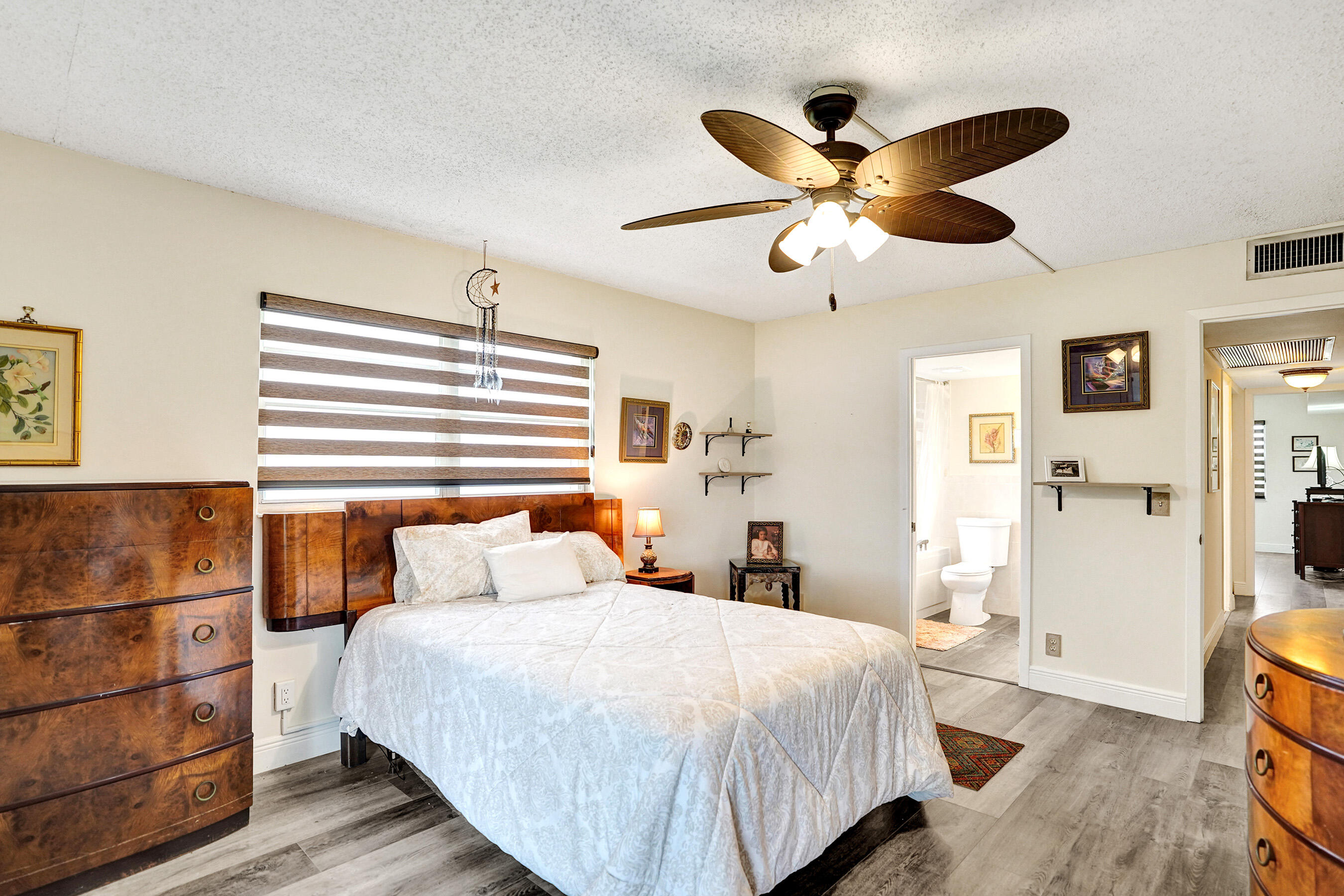 1033 Ainslie C Boca Raton, FL 33434 - Photo 30 of 42 a bedroom with a bed and a chandelier