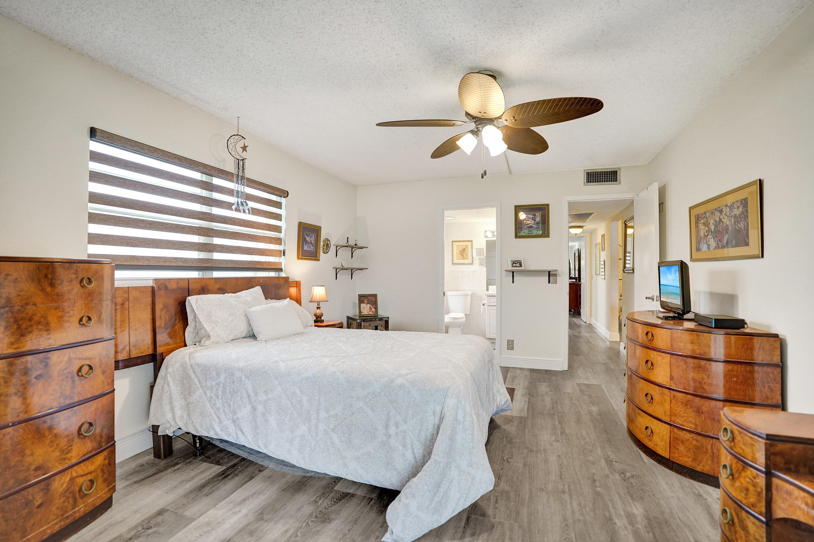 1033 Ainslie C Boca Raton, FL 33434 - Photo 31 of 42 a bedroom with a bed and wooden floor